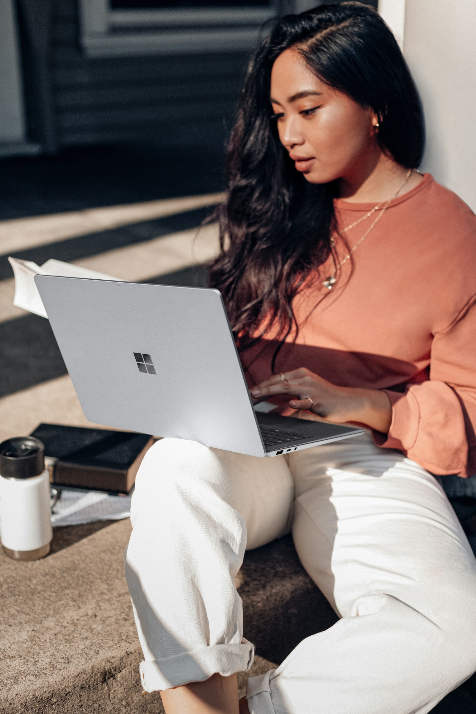 A founder working on a laptop in the sun